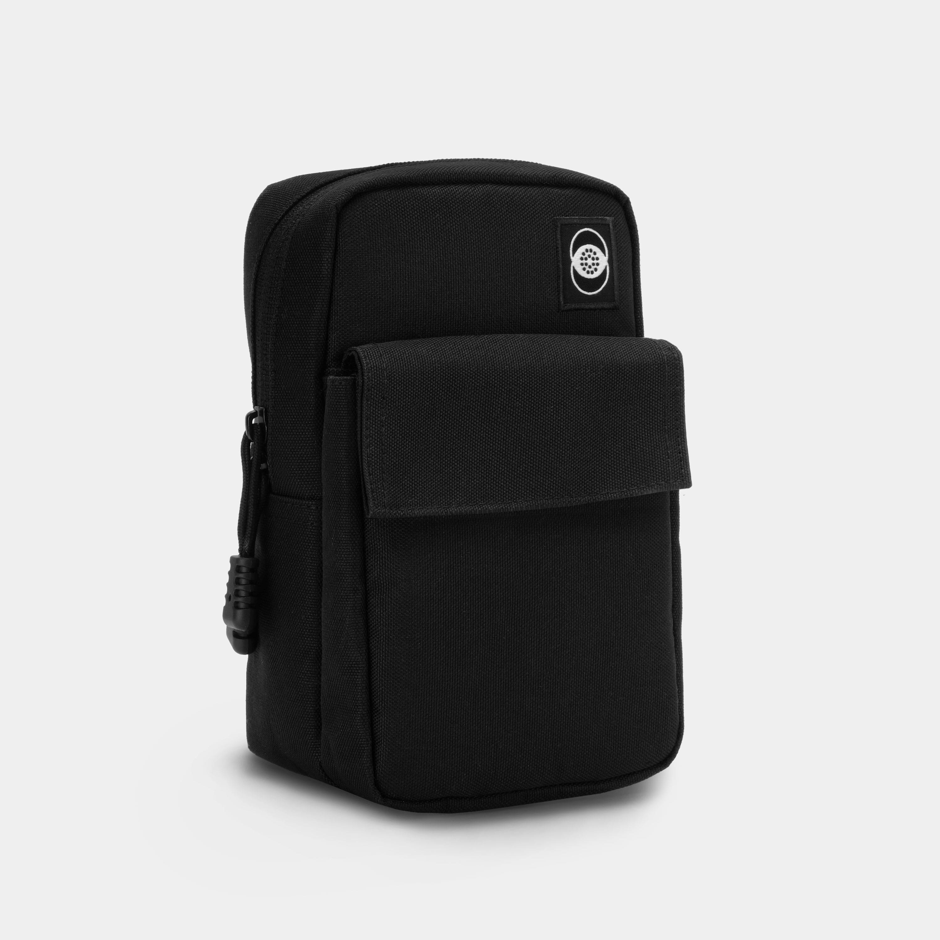 Retrospekt SX-70 Camera Bag being placed on a wooden desk with camera, film pack, and phone inside